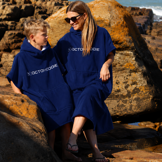 A woman and a boy wearing matching navy blue Octohoodies short-sleeve