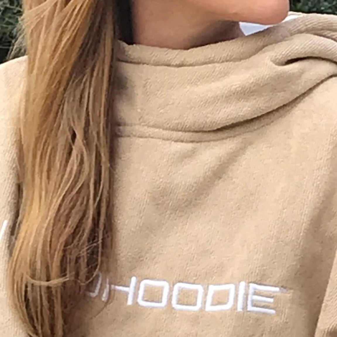 Person wrapped in a beige Octohoodie 3/4 sleeve