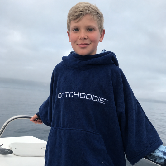 Boy on a boat wearing a long-sleeved Octohoodie
