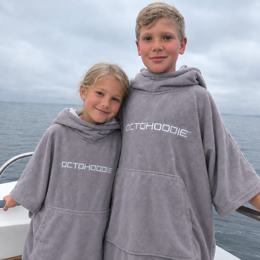 Siblings on a boat in Thunder Grey Octohoodie long-sleeved