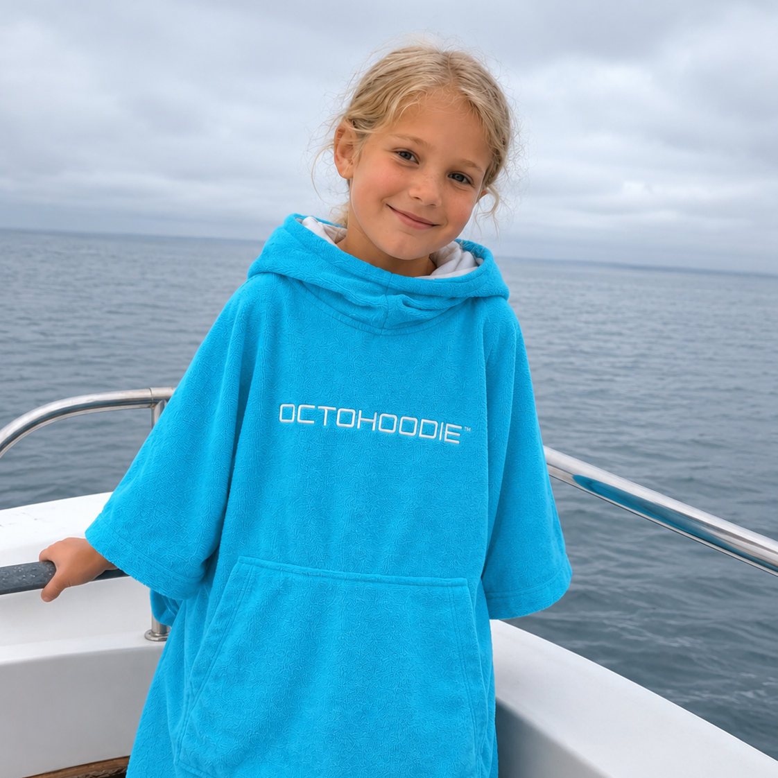 Girl on a boat in a Turquoise long-sleeved Octohoodie