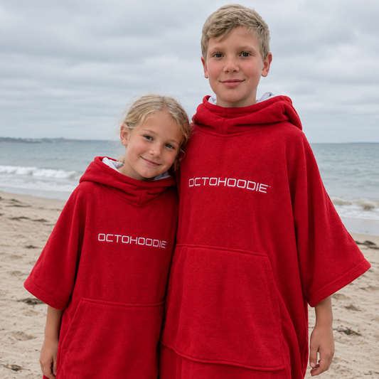 Siblings at the beach in red long-sleeved Octohoodie